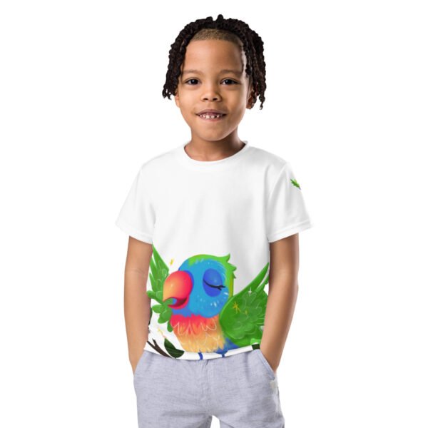 A smiling child wearing a white, all-over print t-shirt featuring a vibrant, colorful parrot design with green wings and a peaceful expression.